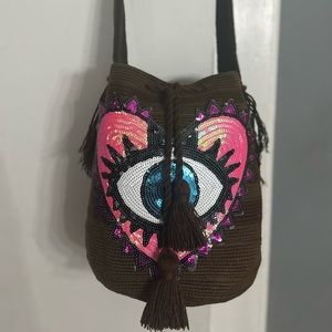 Hand made crochet crossbody bag with evil eye appliqués.  Wayuu style